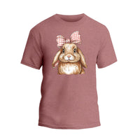 a pink t - shirt with a picture of a rabbit wearing a bow
