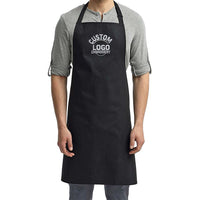 a man wearing a black apron and grey shirt