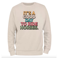 a white sweatshirt that says it's a good day to ride horses