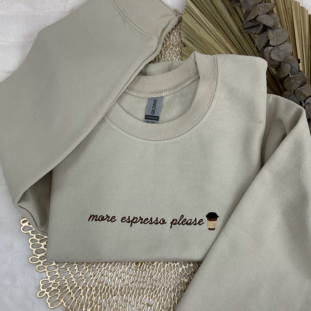 a sweater with a cup of coffee embroidered on it