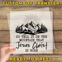 a hand holding a piece of paper with a mountain scene on it