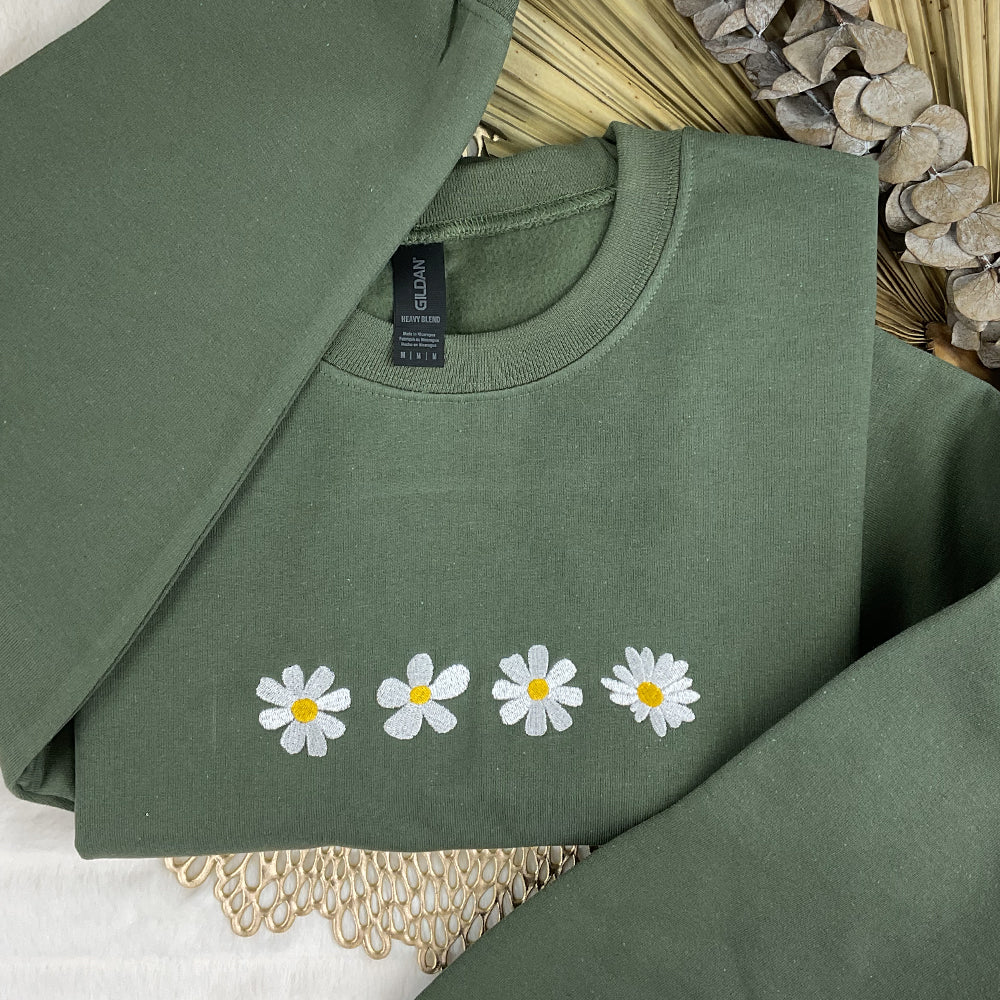 a green shirt with white daisies on it