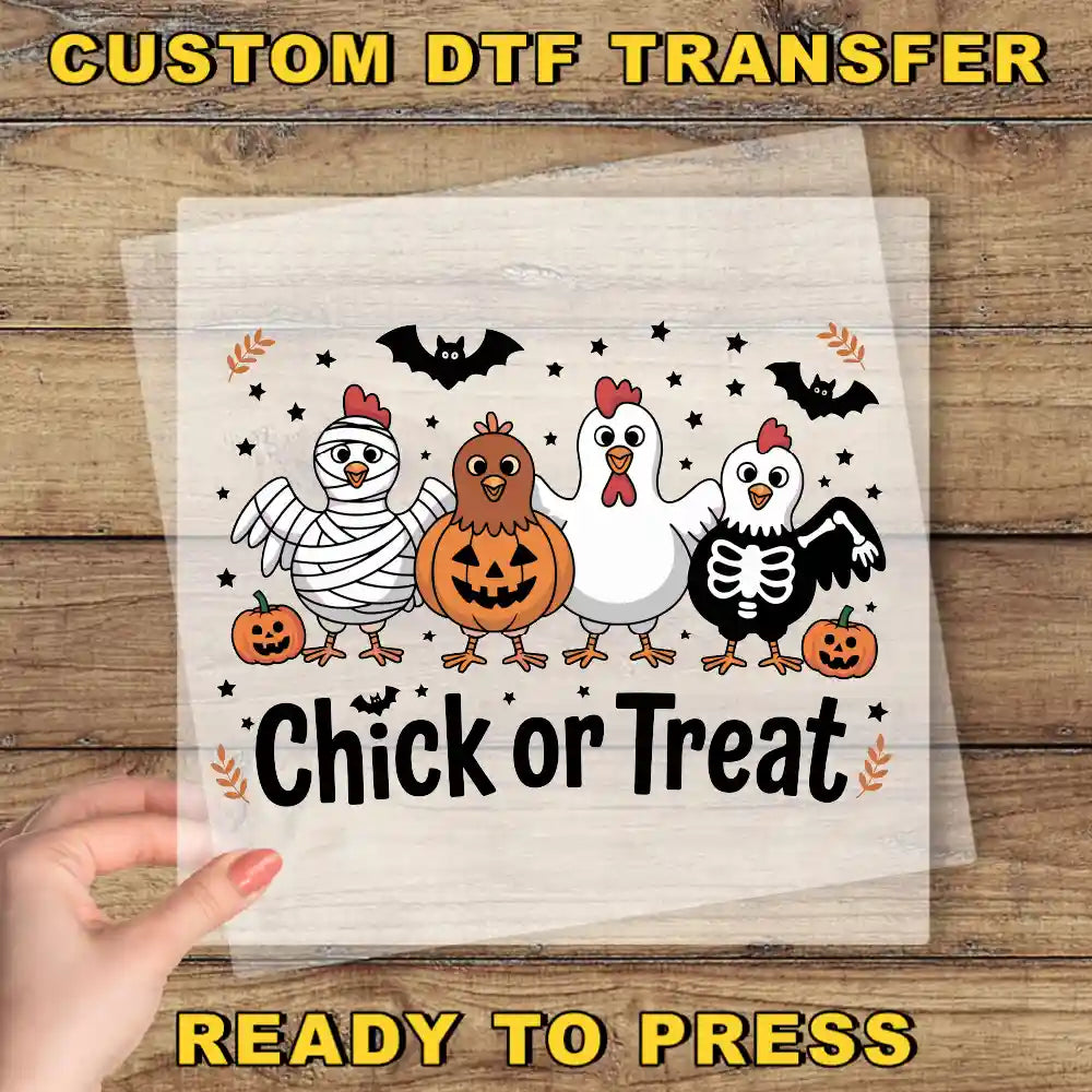 A hand is holding a clear sheet with a Halloween-themed illustration of chickens and a pumpkin, along with the text "Chick or Treat".