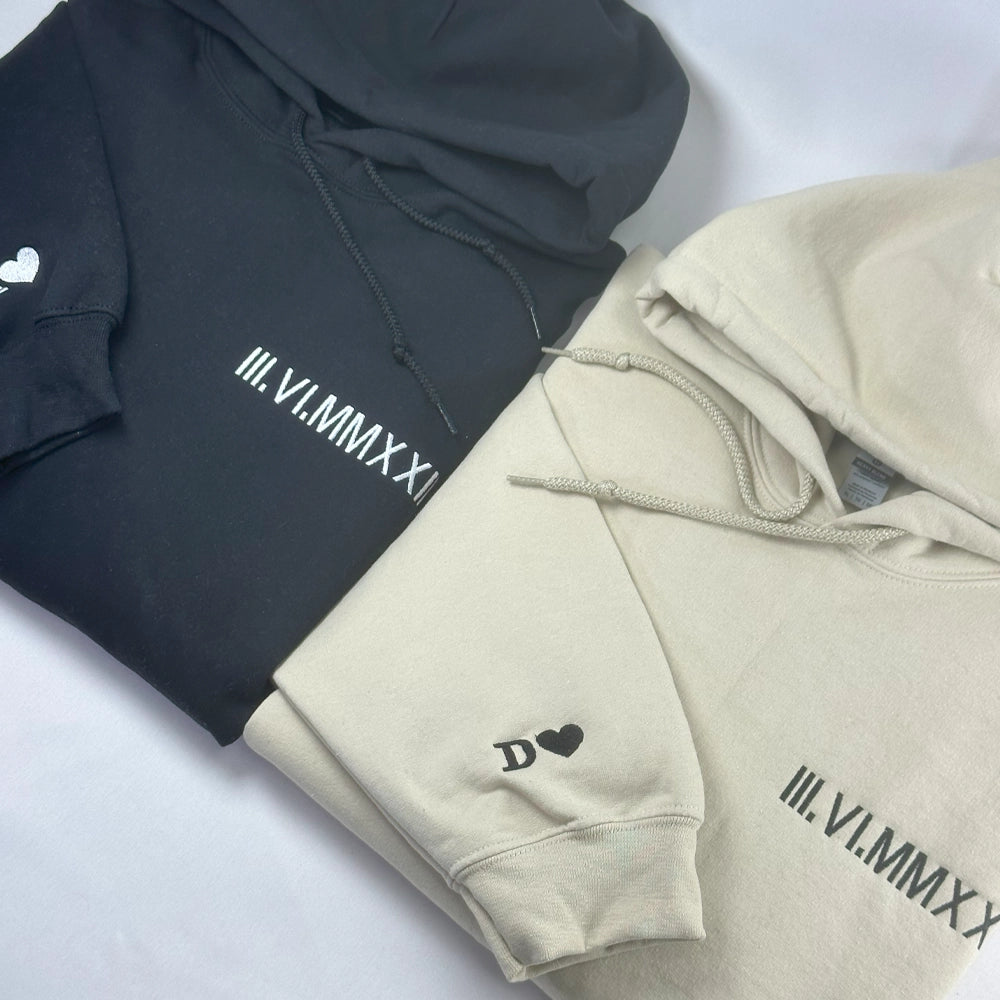 a couple of sweatshirts sitting on top of a bed