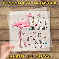 a pink flamingo with the words, i am the woman to blame