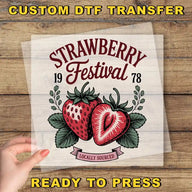 The image is a promotional poster for the Strawberry Festival, featuring a hand holding a transparent sheet with the festival's logo and text.