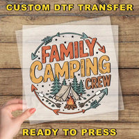 a hand holding a paper with the words family camping crew on it
