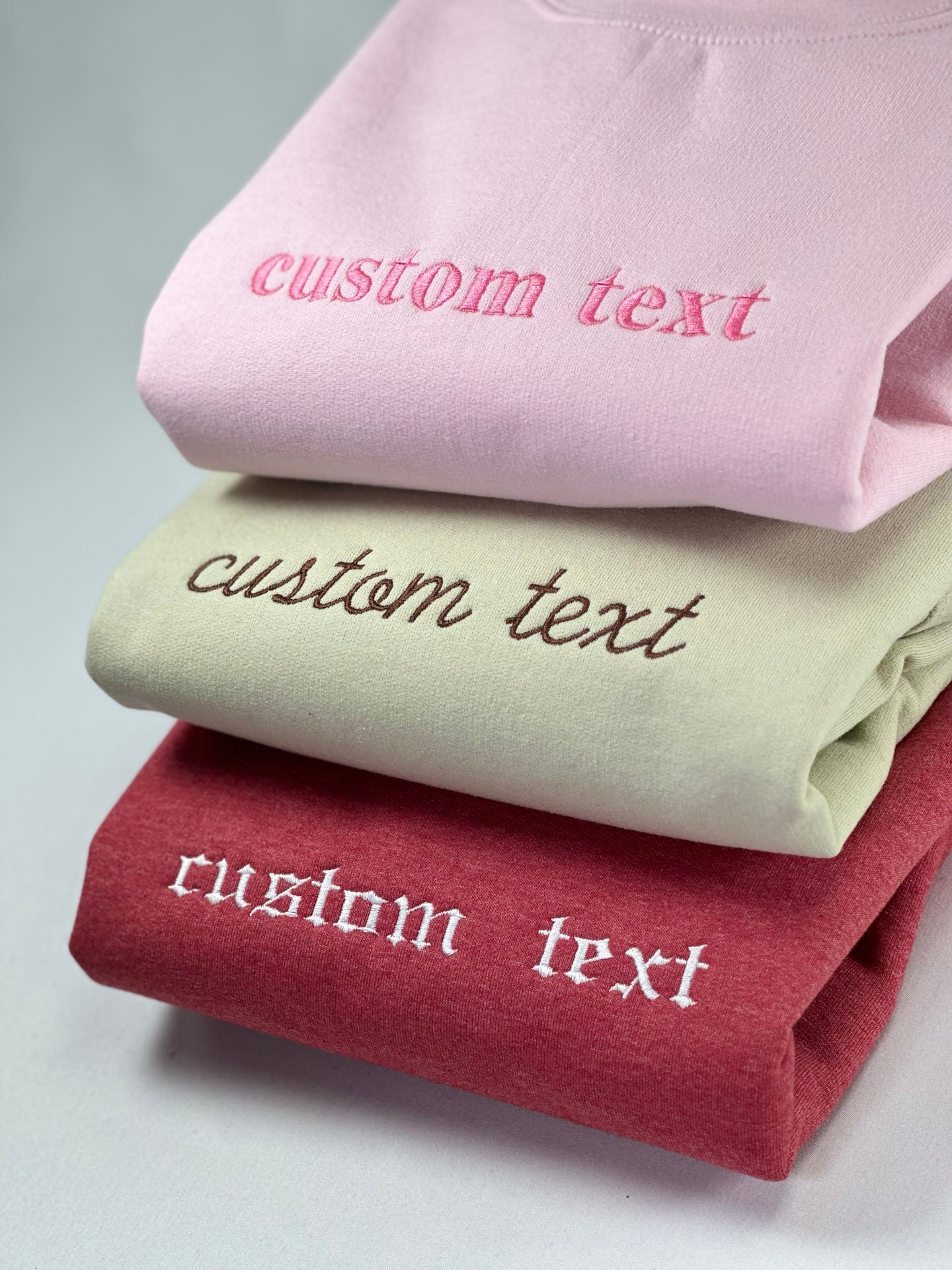 a stack of folded towels with a custom text on them
