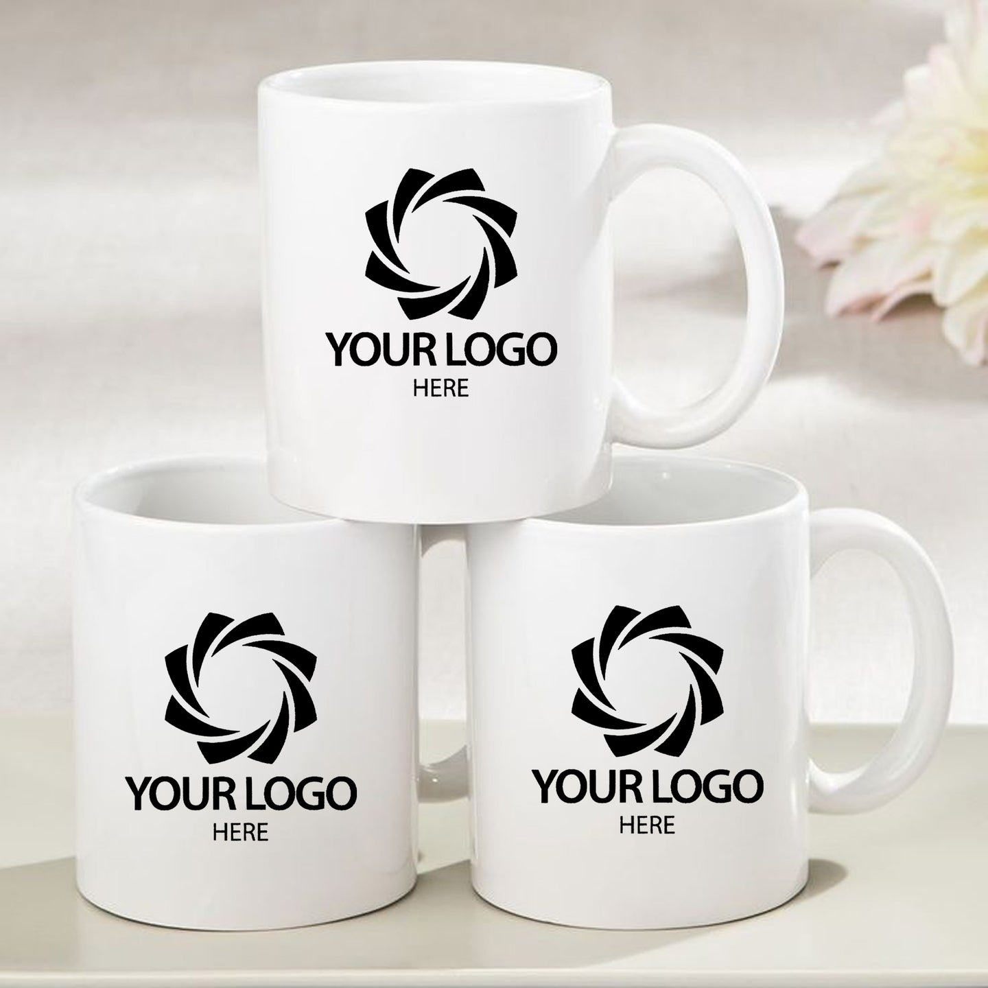 three white coffee mugs sitting on top of a table