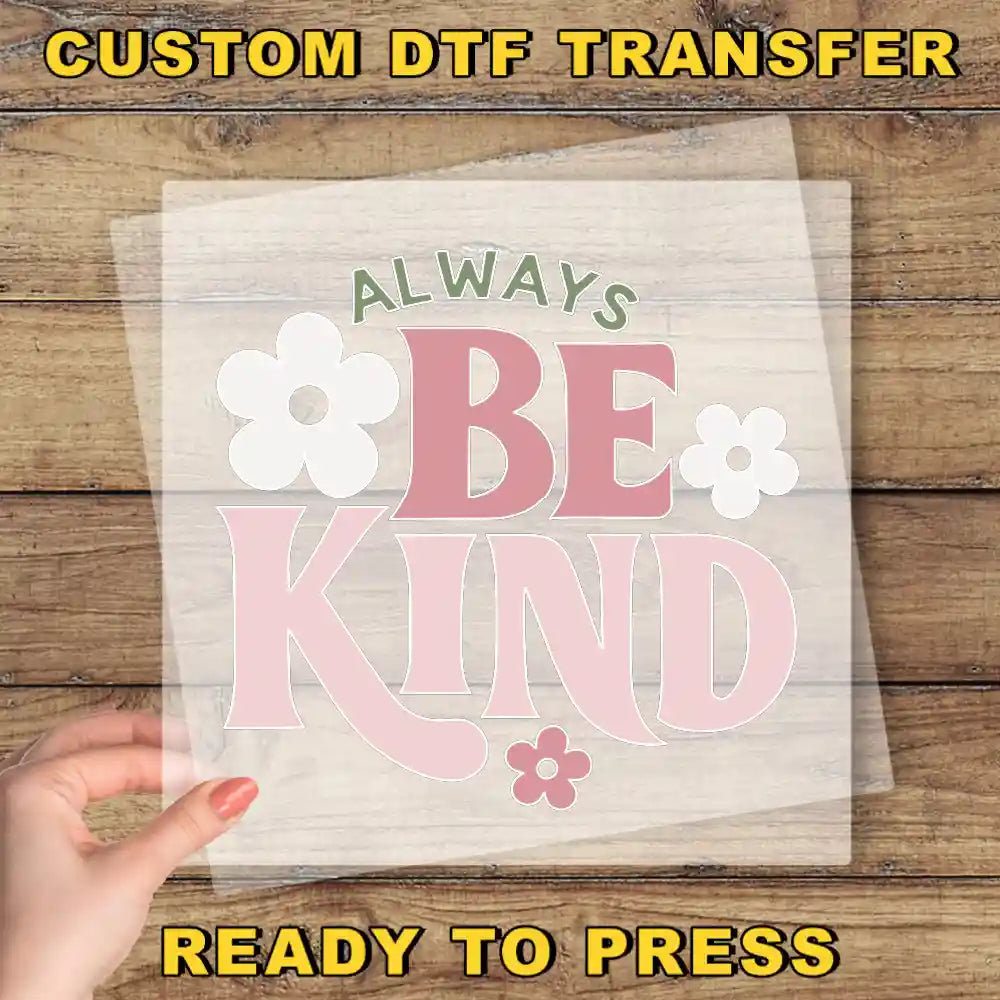 a person holding a piece of paper with the words be kind on it