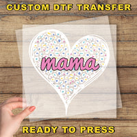 a hand holding a piece of paper with the word mama printed on it