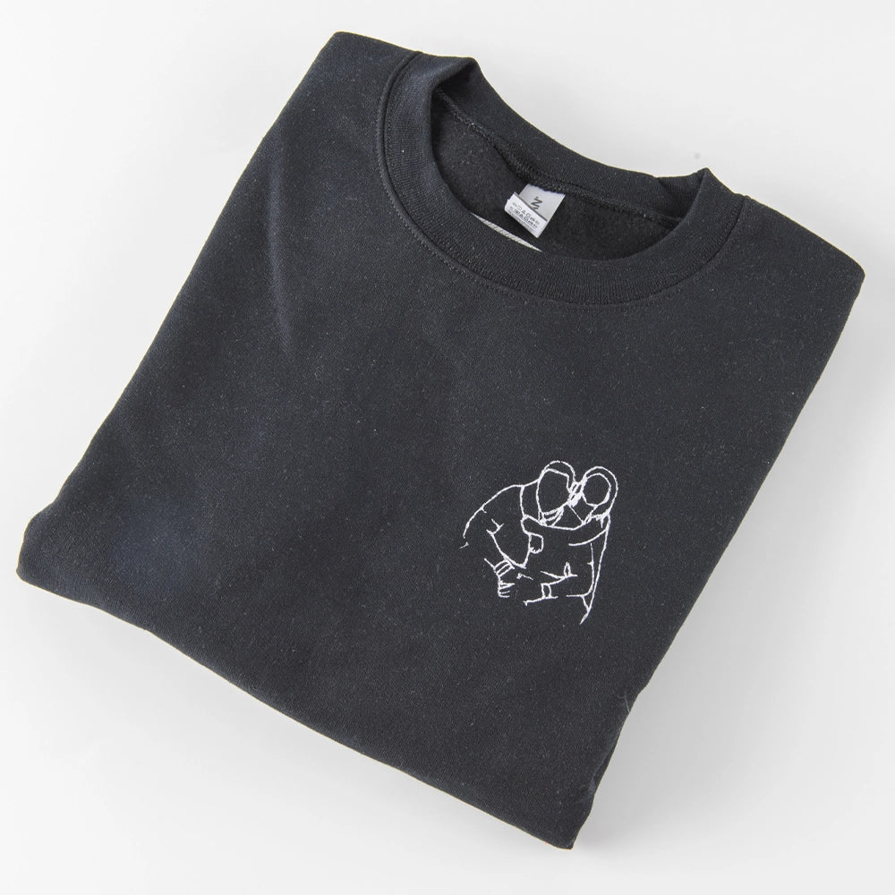 a black t - shirt with a picture of two people hugging