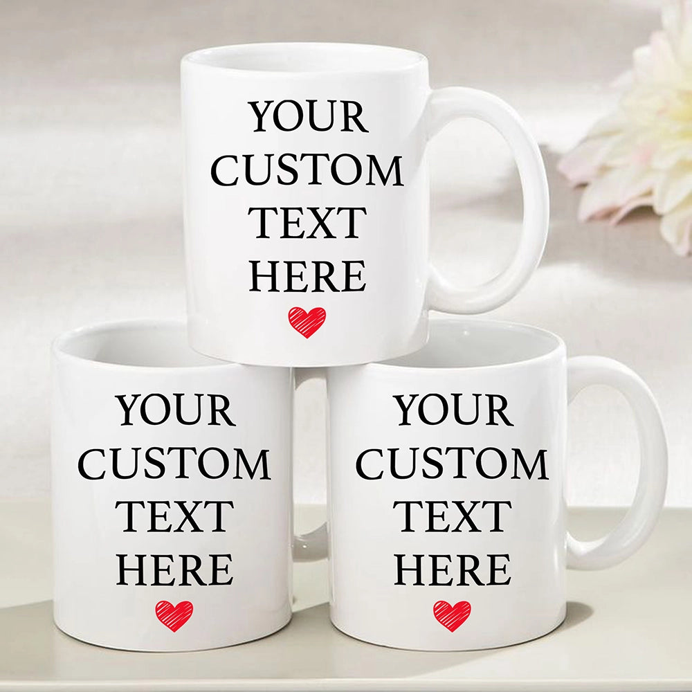 three white coffee mugs with a red heart on them