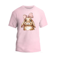 a pink t - shirt with an image of a rabbit wearing a bow