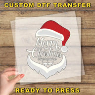 a hand holding a transparent sheet with a stylized Santa Claus design and the text "Merry Christmas everyone" printed on it.