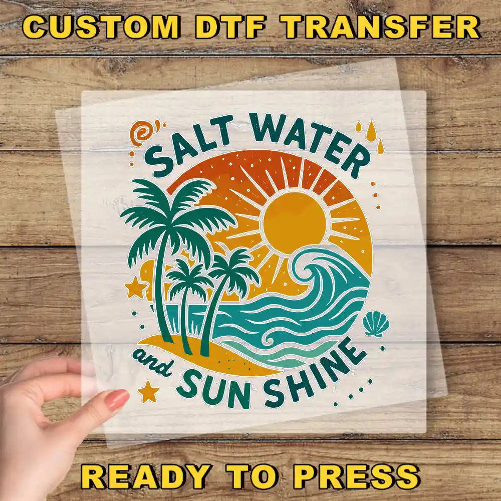 a hand holding a clear plastic sheet with a colorful graphic design of a beach scene, including palm trees, a sun, and waves.