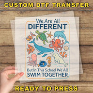 The image is a hand holding a clear sheet with a colorful illustration of various sea animals, including a whale, octopus, and starfish, along with the text "We Are All Different But in This School We All Swim Together".