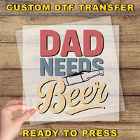 a person holding a piece of paper with the words dad needs beer