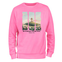 a pink sweatshirt with a cross on it