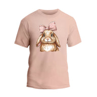 a pink t - shirt with a picture of a rabbit wearing a bow
