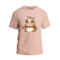 a pink t - shirt with a picture of a rabbit wearing a bow