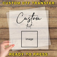 A hand holding a transparent sheet with the text "Custom Dtf Transfer" and "image" written on it, along with the phrase "Ready to Press" at the bottom.