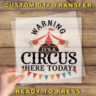 a person holding up a sign with a circus tent in the background