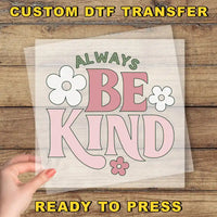 a person holding a paper with the words be kind on it