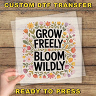 a hand holding a piece of paper that says grow freely, bloom wildly