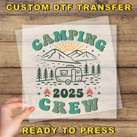 a hand holding a piece of paper with the words camping crew printed on it