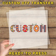 a hand holding a piece of paper with the word "CUSTOM" written on it, along with some colorful decorative elements.