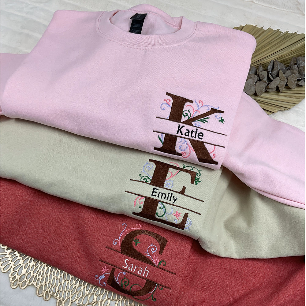 a pile of personalized shirts on top of a bed