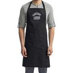 a man wearing a black apron and grey shirt