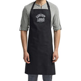 a man wearing a black apron and grey shirt