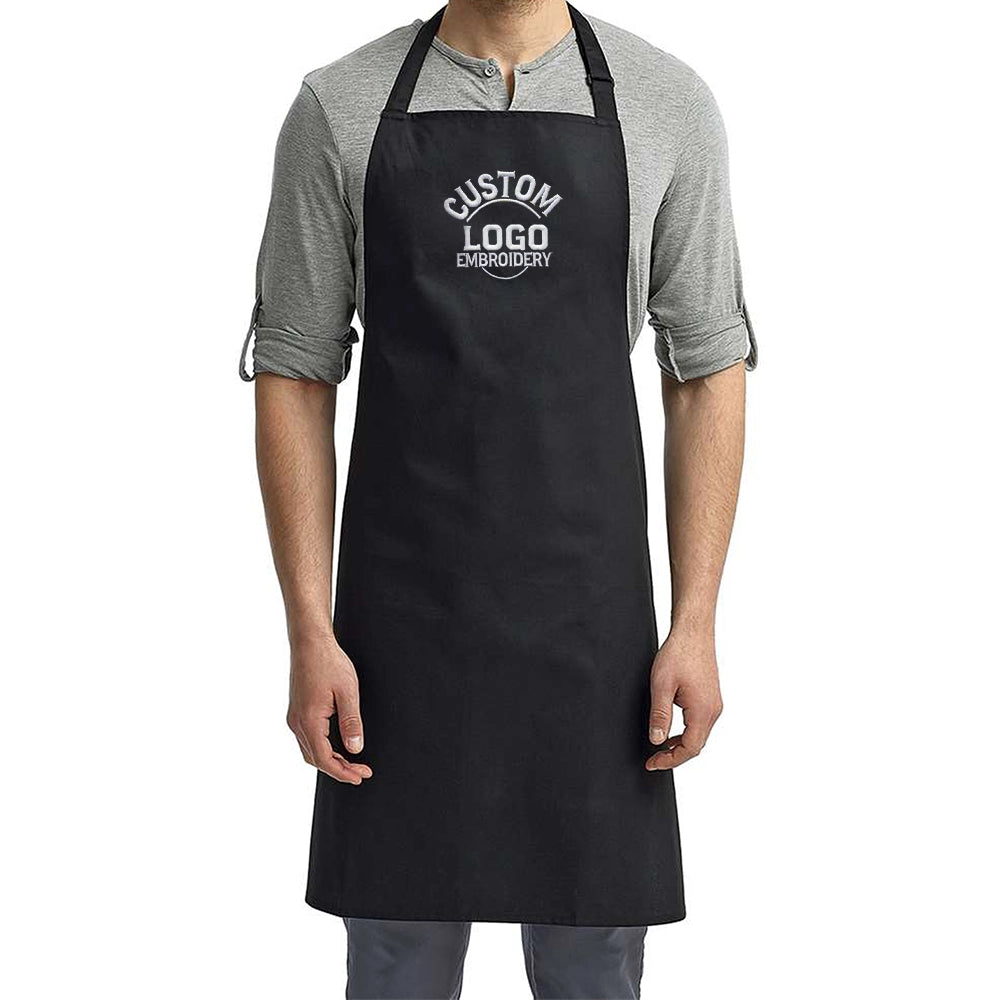 a man wearing a black apron and grey shirt