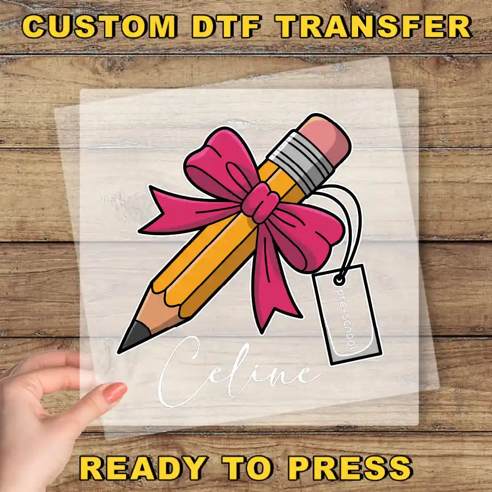 a hand holding a transparent sheet with a pencil and a pink ribbon, with the name "Celine" written below it.