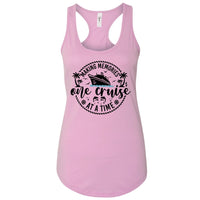 A pink tank top with a graphic design featuring a cruise ship and the text "Making memories one cruise at a time".