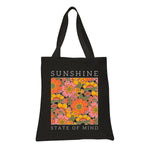 a black tote bag with a picture of flowers on it