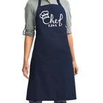 a woman wearing a chef's apron with a chef's name on it