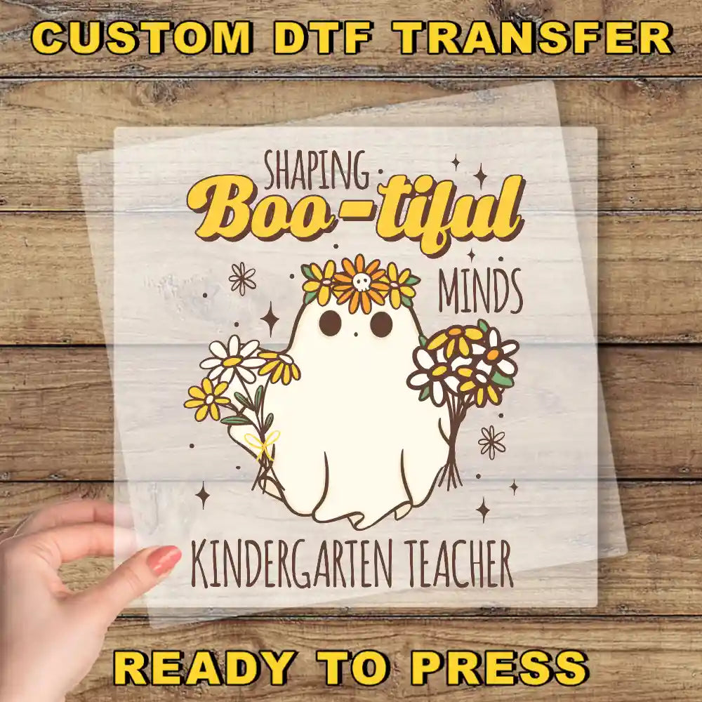 a hand holding a paper with a picture of a ghost on it