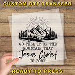a hand holding a piece of paper with a mountain scene on it