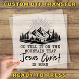 a hand holding a piece of paper with a mountain scene on it