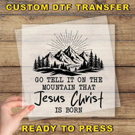 a hand holding a piece of paper with a mountain scene on it