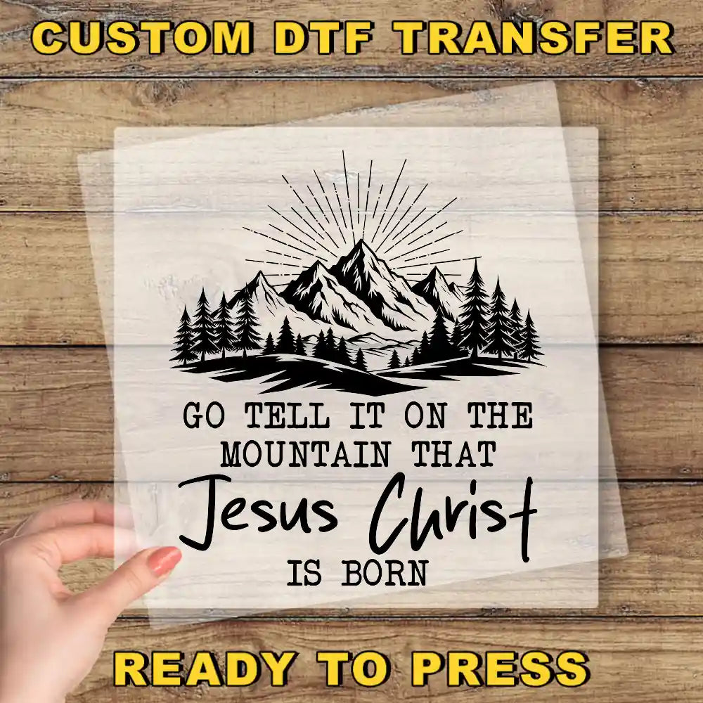 a hand holding a piece of paper with a mountain scene on it