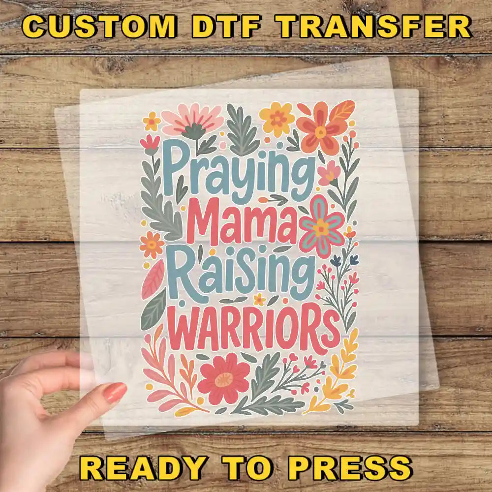 a person holding up a paper with the words praying mama raising warriors on it