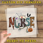 a hand holding a piece of paper with a custom DTF transfer design that says "NURSE" in a creative and playful manner.