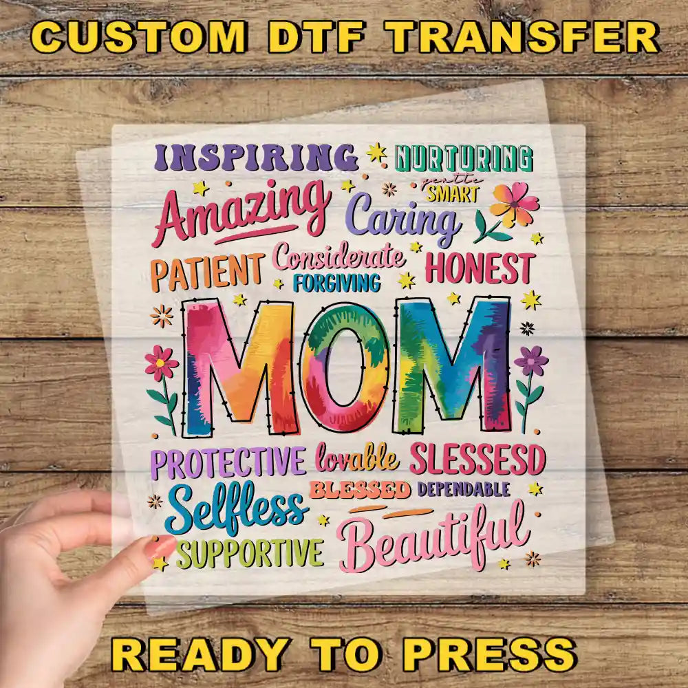 a hand holding up a piece of paper with the words mom on it