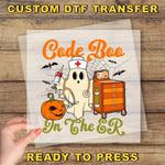 a hand holding a paper with a picture of a ghost on it