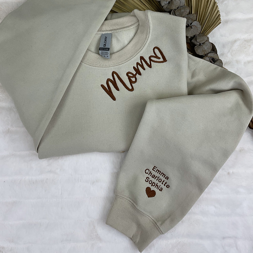 a couple of sweatshirts sitting on top of a bed