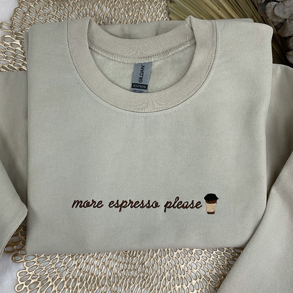 a sweater with a cup of coffee embroidered on it